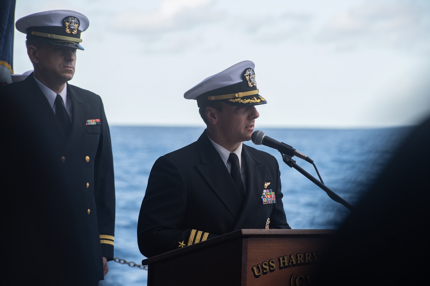 Cmdr.  Matthew Enos, executive officer of Strike Fighter Squadron (VFA) 11, gave a eulogy for his father during a buria at sea aboard the Nimitz-class aircraft carrier USS Harry S. Truman (CVN 75), Dec. 11, 2021.