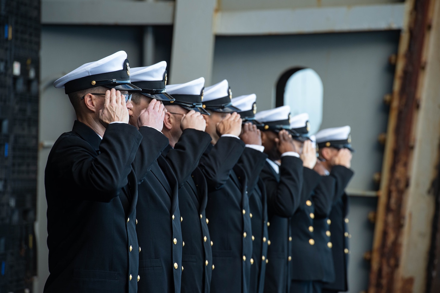 And all Command Master Chief honor guard renders honors during a burial-at-sea aboard the Nimitz-class aircraft carrier USS Harry S. Truman (CVN 75), Dec. 11, 2021.