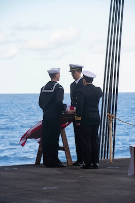 Sailors commit cremains to the deep during a burial-at-sea aboard the aircraft carrier USS Harry S. Truman (CVN 75), Dec. 11, 2021.