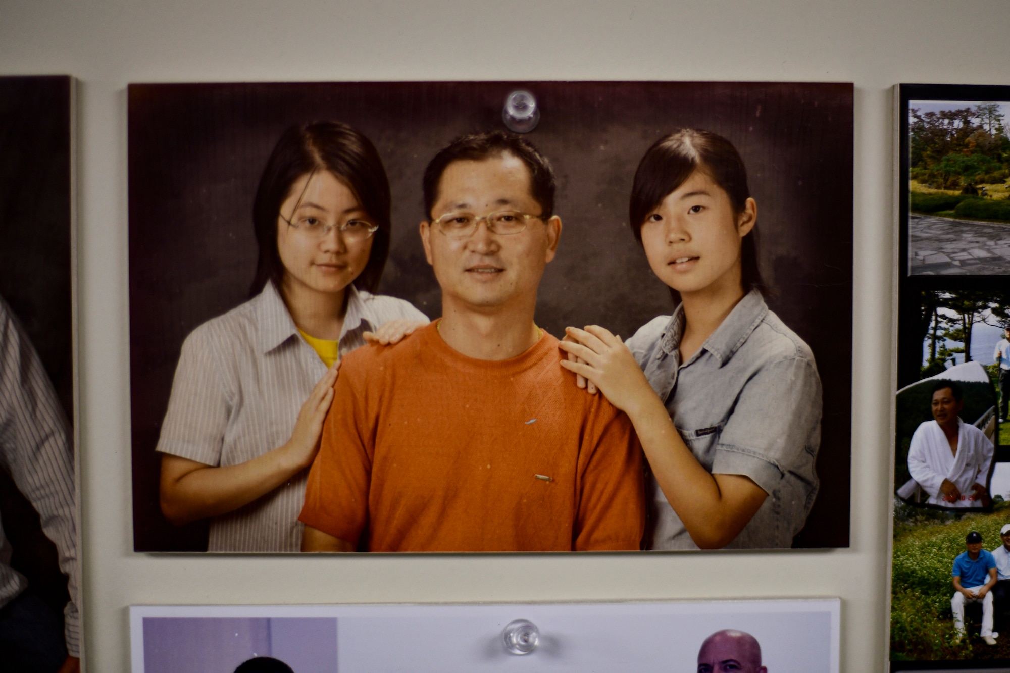 A photo of a graphics technician and his daughters hangs on the wall.