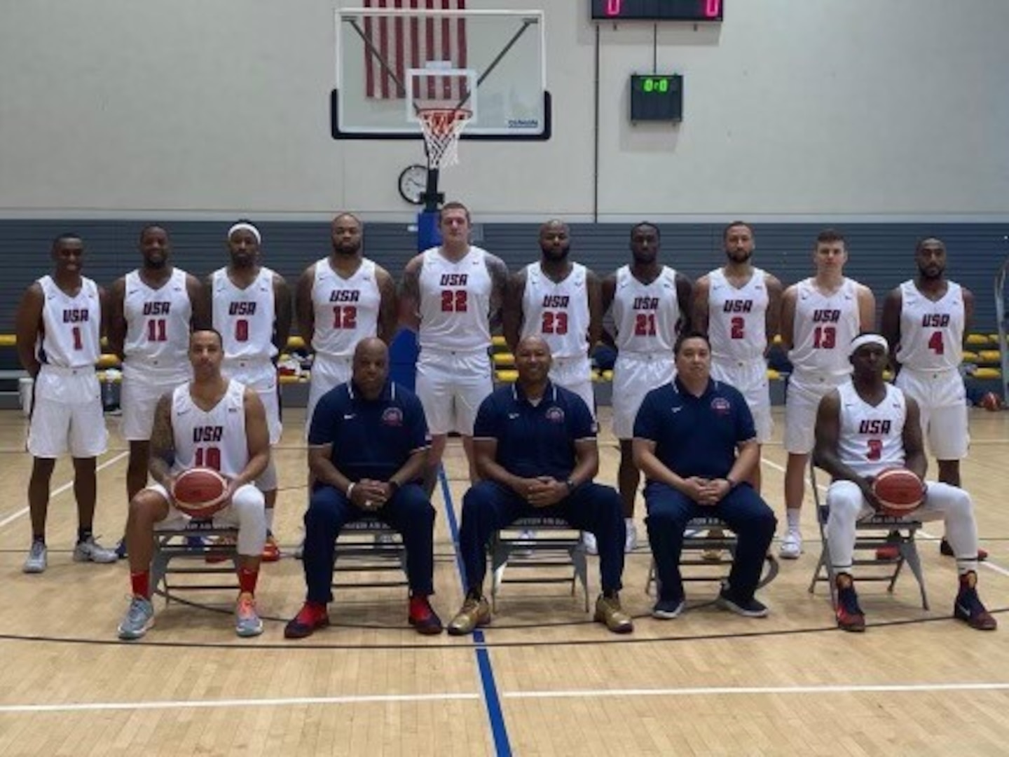 U.S. Coast Guard Cmdr. Micah Bonner, Director of Auxiliary Southern Region for the First Coast Guard District and head coach of the USA Armed Forces Men’s Basketball Team, poses with members of the team before playing in the Supreme Headquarters Allied Powers Europe (SHAPE) International Basketball Tournament (IBT) in Mons, Belgium, November 2021. The annual tournament brings teams from around the world together to a NATO installation for friendly competition and partnership. (U.S. Coast Guard courtesy photo)