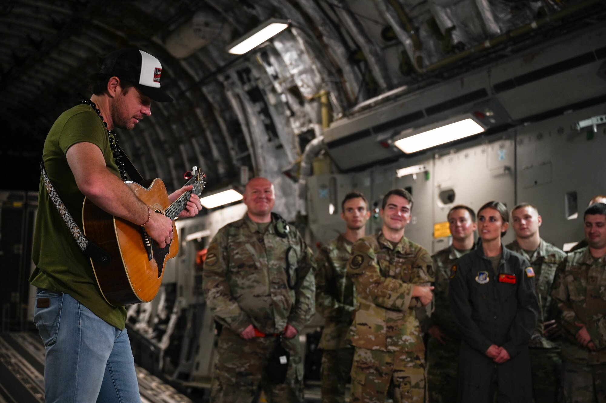 Matt Stell, country music artist, performs for Airmen assigned to the 15th Wing in the fuselage of a C-17 Globemaster III after filming for CMT’s Hot 20 Annual Holiday Salute to the Troops at Joint Base Pearl Harbor-Hickam, Hawaii, Nov. 29, 2021. Stell and Cody Alan, Country Music Television Radio host and executive producer, toured the 15th Maintenance Group, a C-17 Globemaster III and a KC-135 Stratotanker while touring JBPHH. (U.S. Air Force photo by Staff Sgt. Alan Ricker)
