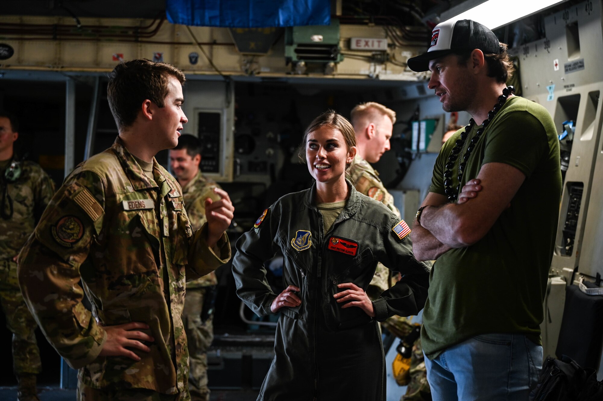 Matt Stell, country music artist, speaks with Airman 1st Class Coleton Edens and Staff Sgt. Payton Glover, 535th Airlift Squadron C-17 Globemaster III loadmasters, after filming for CMT’s Hot 20 Annual Holiday Salute to the Troops at Joint Base Pearl Harbor-Hickam, Hawaii, Nov. 29, 2021. Stell joined Cody Alan, Country Music Television Radio host and executive producer, during a tour highlighting JBPHH Airmen. (U.S. Air Force photo by Staff Sgt. Alan Ricker)