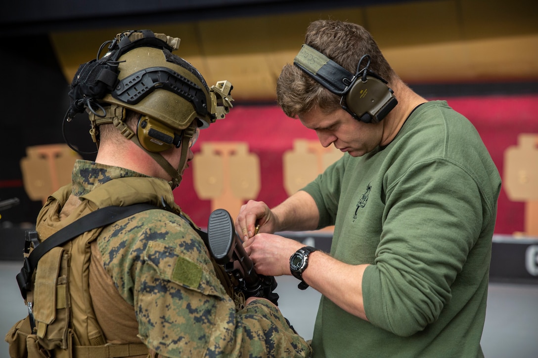 U.S. Marine Corps Lance Cpl. Trenton Z. Brown, a rifleman and team leader with Recapture Tactics Team, Marine Corps Security Force Regiment, and British Royal Marine Cpl. Michael Dowd, an armored support group team member with 43 Commando Fleet Protection Group Royal Marines, adjusts a battle sight zero on a C8 assault rifle during exercise Tartan Eagle Phase II, Northumbria Police Range, Wallsend, England, Dec. 11, 2021. This range allowed U.S. Marines to operate alongside British Royal Marines in a similar occupation field while conducting movement-to-contact and pistol drills. Exercise Tartan Eagle is a bilateral biyearly training exercise for the U.S. Marines and British Royal Marines to train close-quarters battle strategy and tactics. (U.S. Marine Corps photo by Lance Cpl. Angel Alvarado)