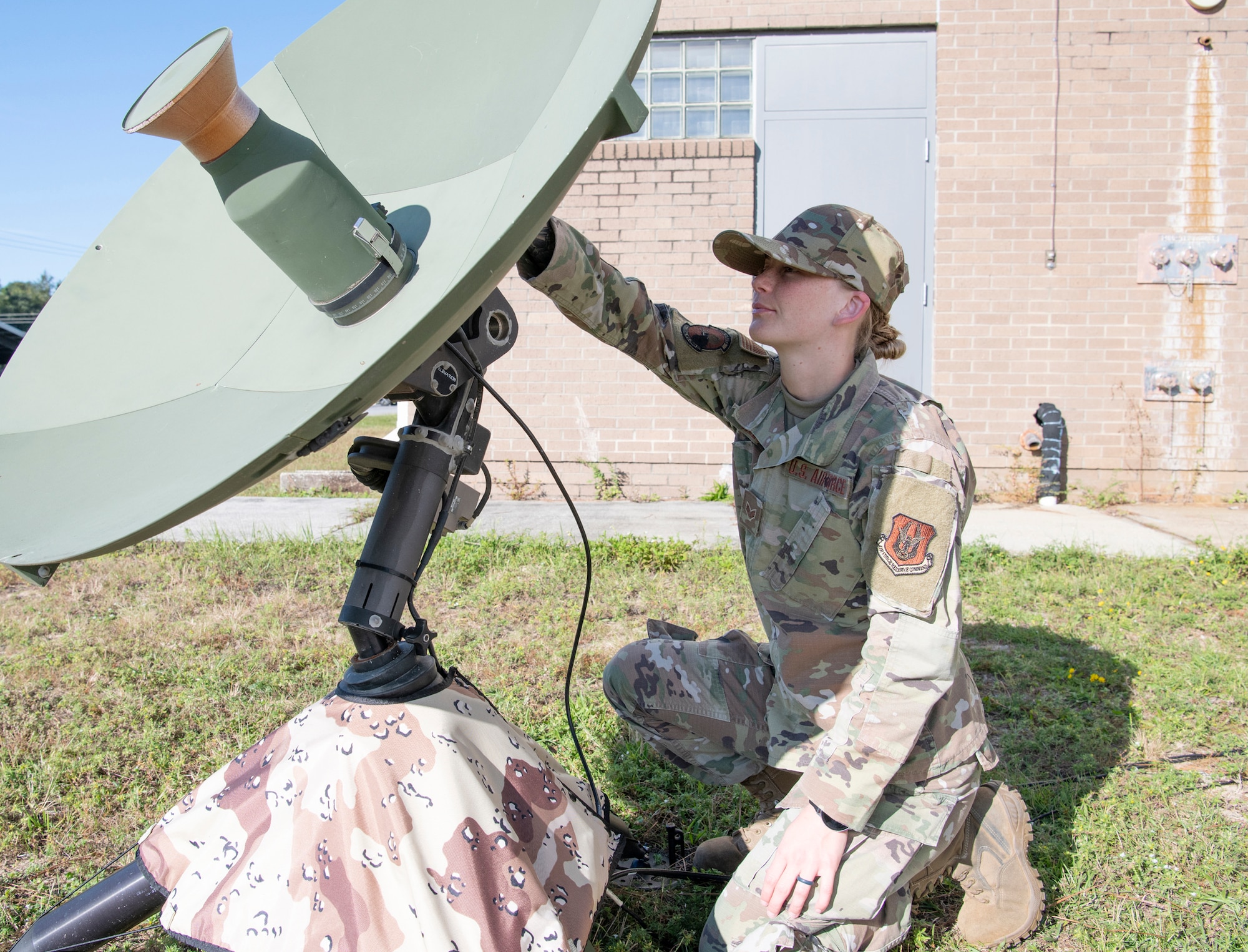 A radio frequency technician configures a data satellite