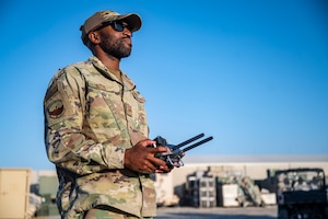 U.S. Air Force Staff Sgt. Daniel Butts, 386th Expeditionary Security Forces Squadron noncommissioned officer in charge of counter-small unmanned aerial systems, pilots a small drone at Ali Al Salem Air Base, Kuwait, Nov. 29, 2021. The 386th ESFS works within the Wing Operations Center at ASAB to monitor and detect the area around the base to protect service members from possible drone threats. (U.S. Air Force photo by Tech. Sgt. Daryn Murphy)