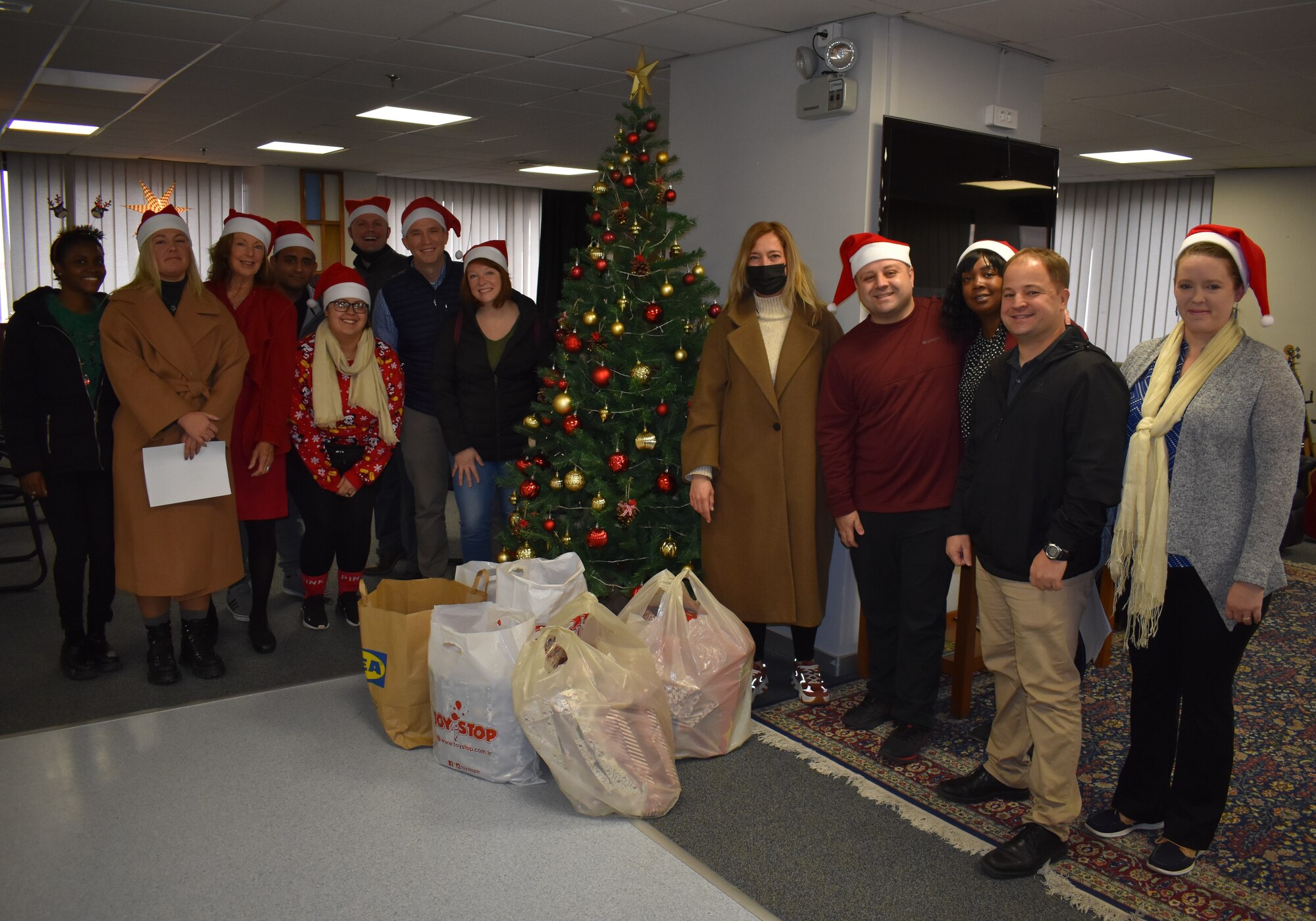 members standing for group photo for the holidays