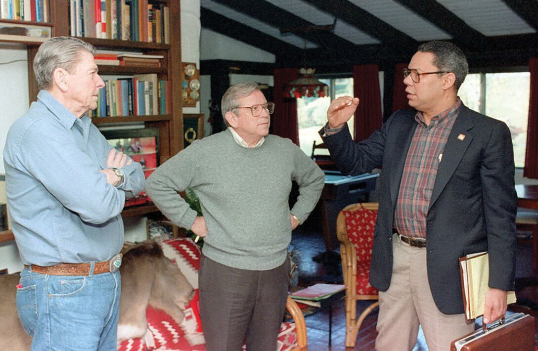 President Ronald Reagan, Chief of Staff Howard Baker, and newly appointed National Security Advisor Powell confer inside Rancho Del Cielo, in California, on November 25, 1987 (Reagan White House/National Archives and Records Administration)