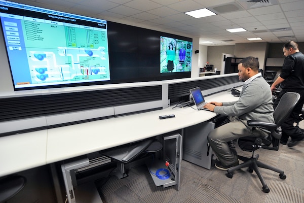 Valentino Floyd, an Enterprise Industrial Control System operator at the Shore Operations Center at the Washington Navy Yard, uses a SmartGrid system to monitor energy usage in area buildings. Operators and analysts at the center maintain command and control of energy usage at the base through a secure network, allowing for more efficient power usage to enable mission readiness and lower operating costs. (U.S. Navy photo by Shawn Miller/Released)