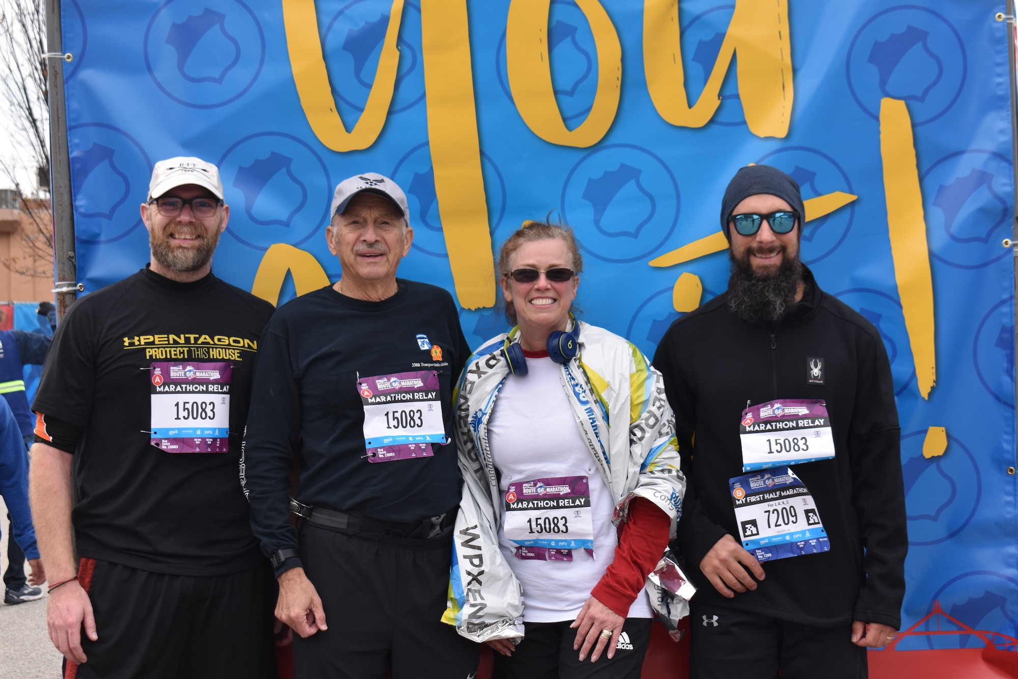 Four runners posing for a group photo