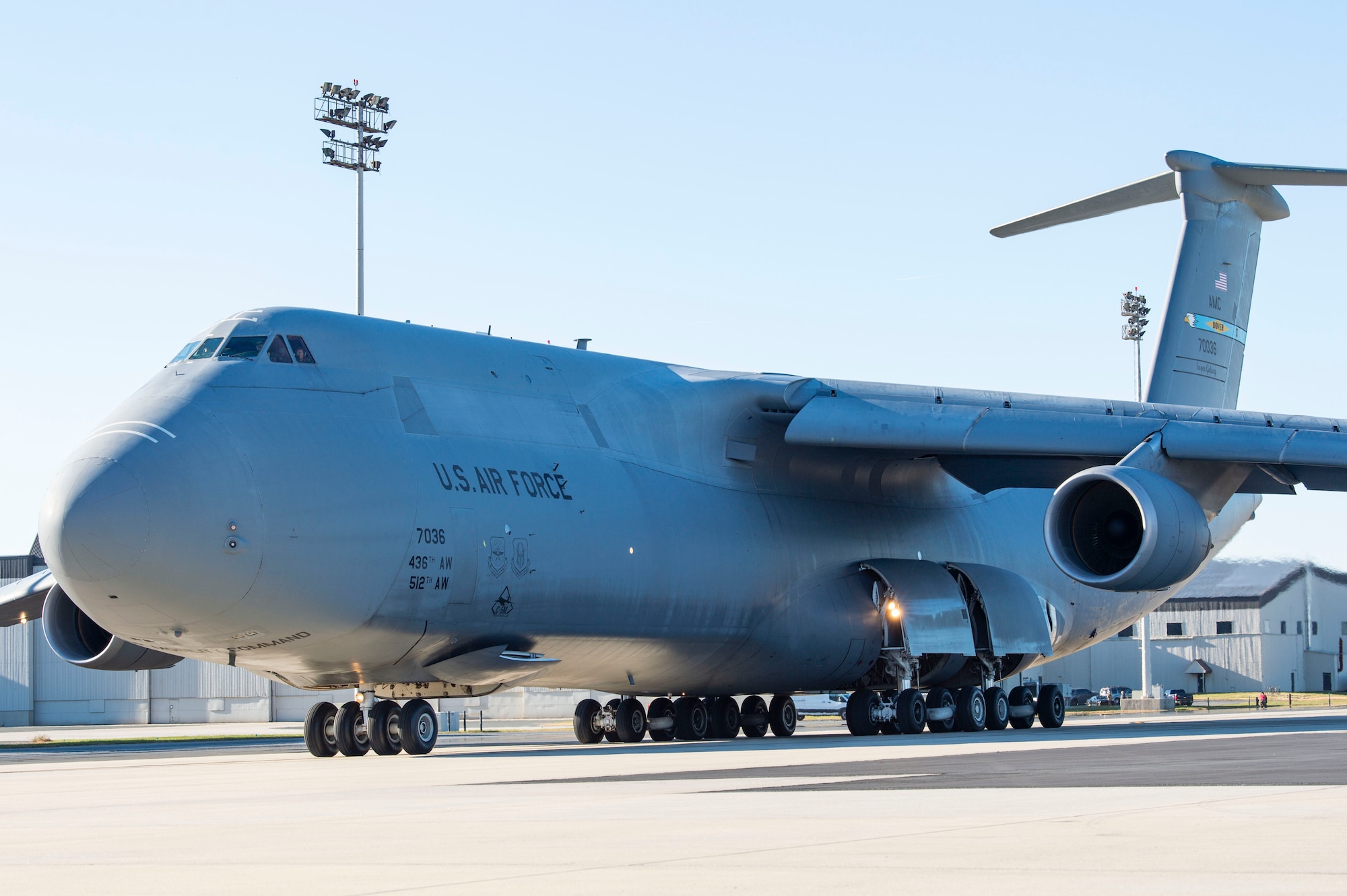 A C-5M Super Galaxy taxis down the flight line prior to takeoff at Dover Air Force Base, Delaware, Dec. 20, 2021. Eighteen C-5M's are assigned to Dover AFB, along with 13 C-17 Globemaster IIIs that provide 20 percent of the nation's outsized airlift capacity. (U.S. Air Force photo by Roland Balik)