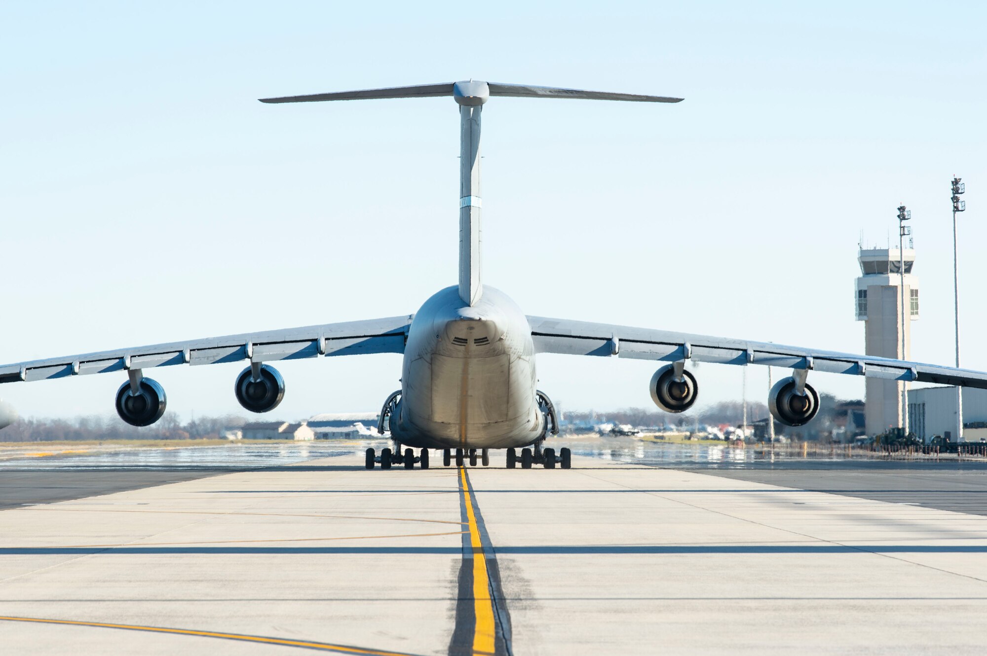 A C-5M Super Galaxy taxis down the flight line toward the runway at Dover Air Force Base, Delaware, Dec. 20, 2021. Eighteen C-5M’s are assigned to Dover AFB, along with 13 C-17 Globemaster IIIs that provide 20 percent of the nation’s outsized airlift capacity. (U.S. Air Force photo by Roland Balik)