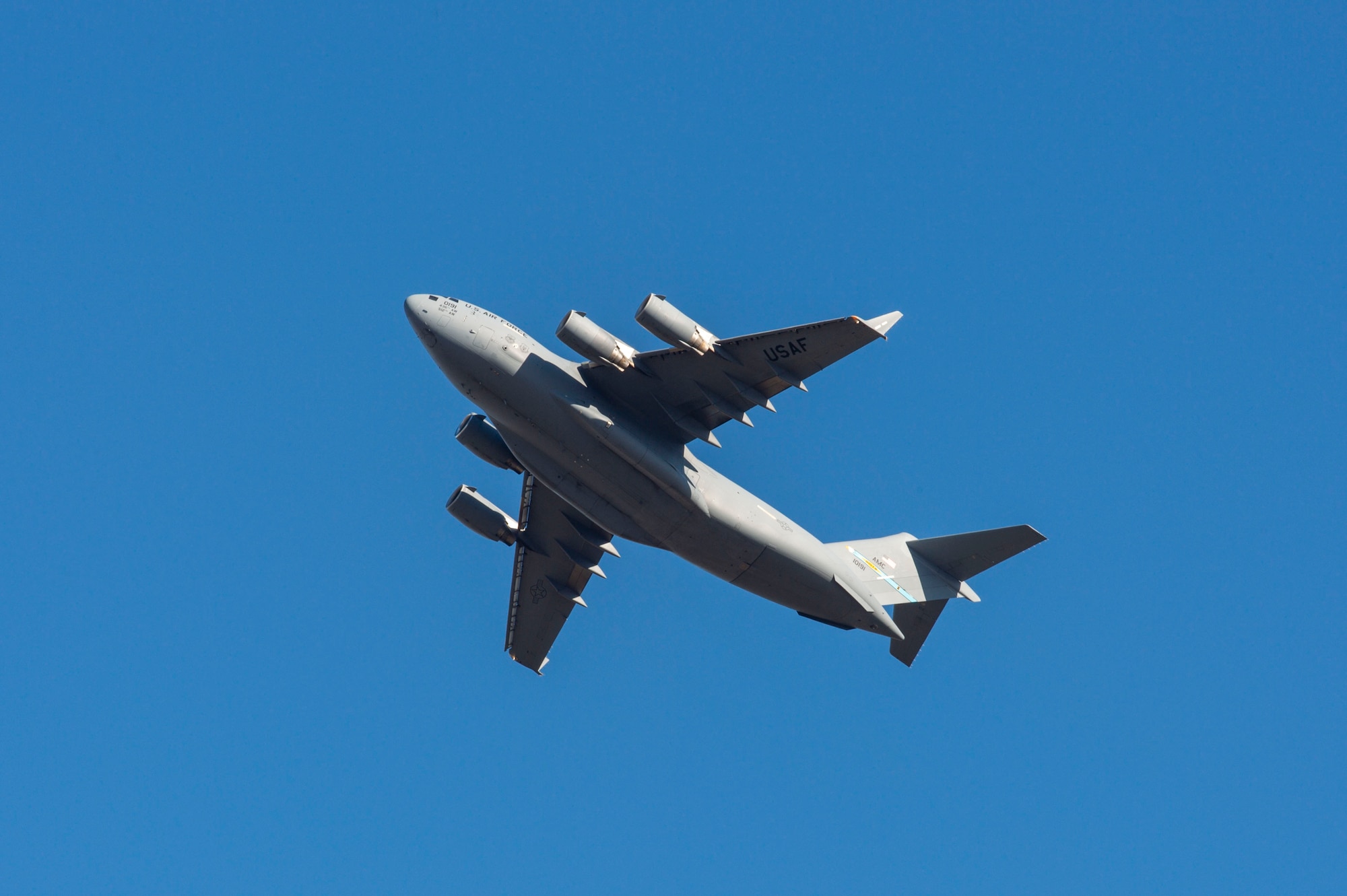 A C-17 Globemaster III completes a touch and go landing during a local training flight at Dover Air Force Base, Delaware, Dec. 20, 2021. Thirteen C-17s are assigned to Dover AFB, along with 18 C-5Ms that provide 20 percent of the nation's outsized airlift capacity. (U.S. Air Force photo by Roland Balik)