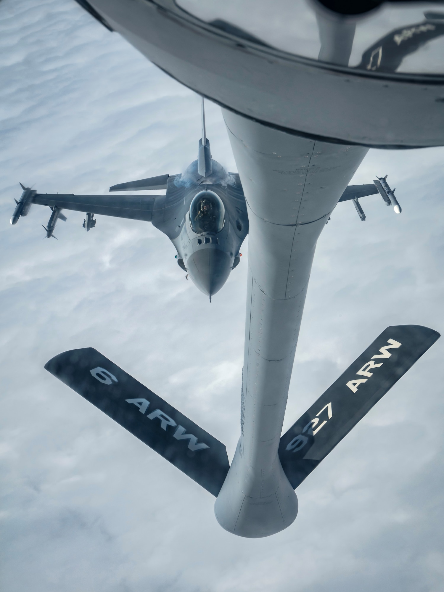 A KC-135 Stratotanker aircraft assigned to MacDill Air Force Base refuels an F-16 Fighting Falcon aircraft assigned to the 187th Fighter Wing, Alabama National Guard, during an exercise over Alabama, Dec. 21, 2021.