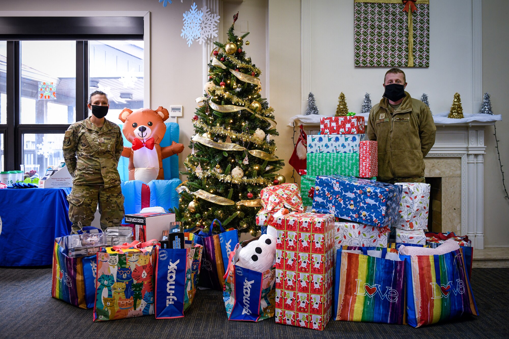 Master Sgt. Renee Mihochi and Master Sgt. Larry Felts, both readiness non-commissioned officers assigned to the 910th Airlift Wing, pose for a photos in front of the Angel Tree, Dec. 5, 2021, in the Kubli Morale and Wellness Center at Youngstown Air Reserve Station.