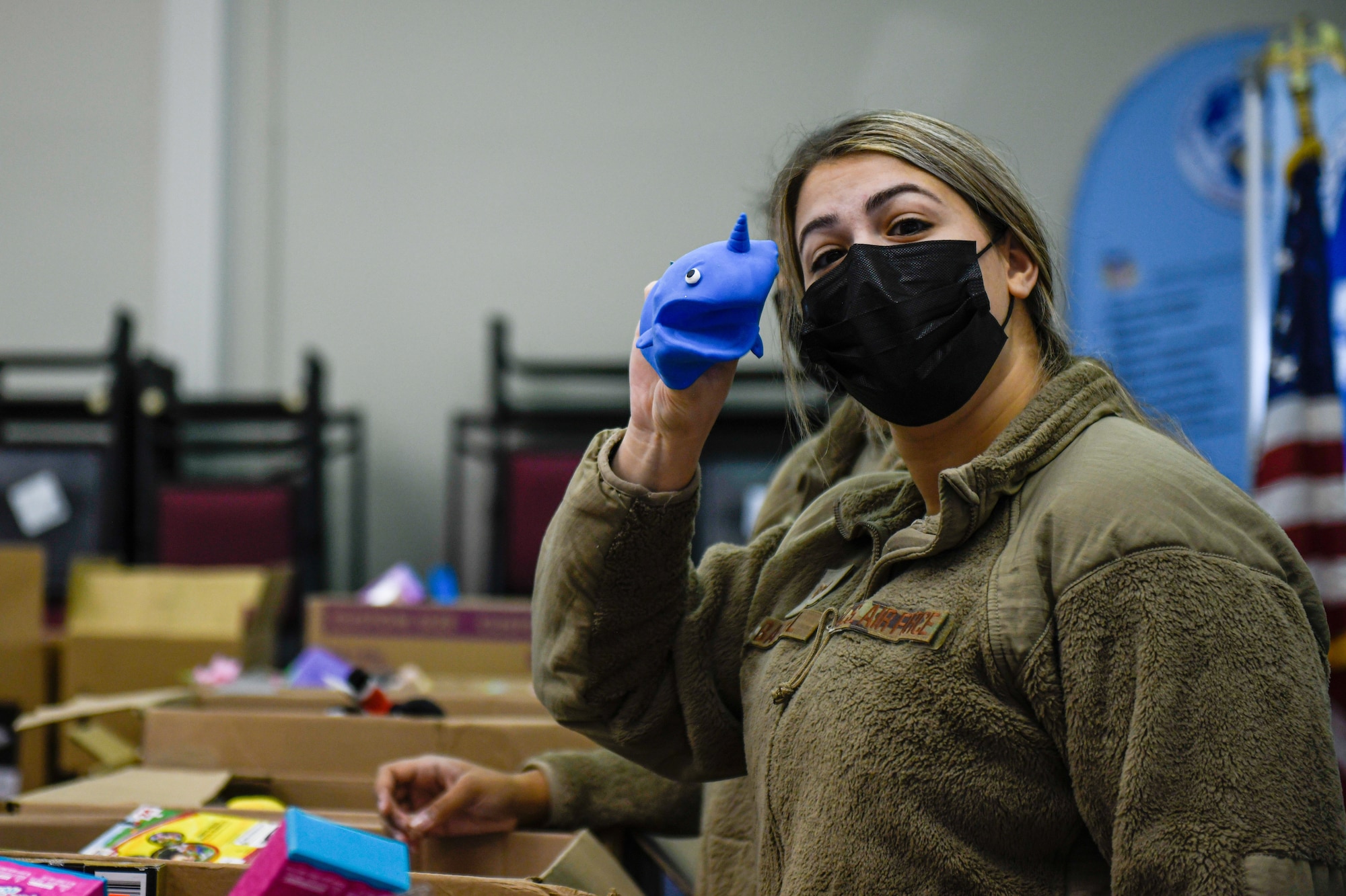 Senior Airman Sabrina Baechel, an education and training specialist assigned to 910th Force Support Squadron, shows off a toy from the Winter Wonderland event, Dec. 5, 2021, in the Kubli Morale and Wellness Center at Youngstown Air Reserve Station.