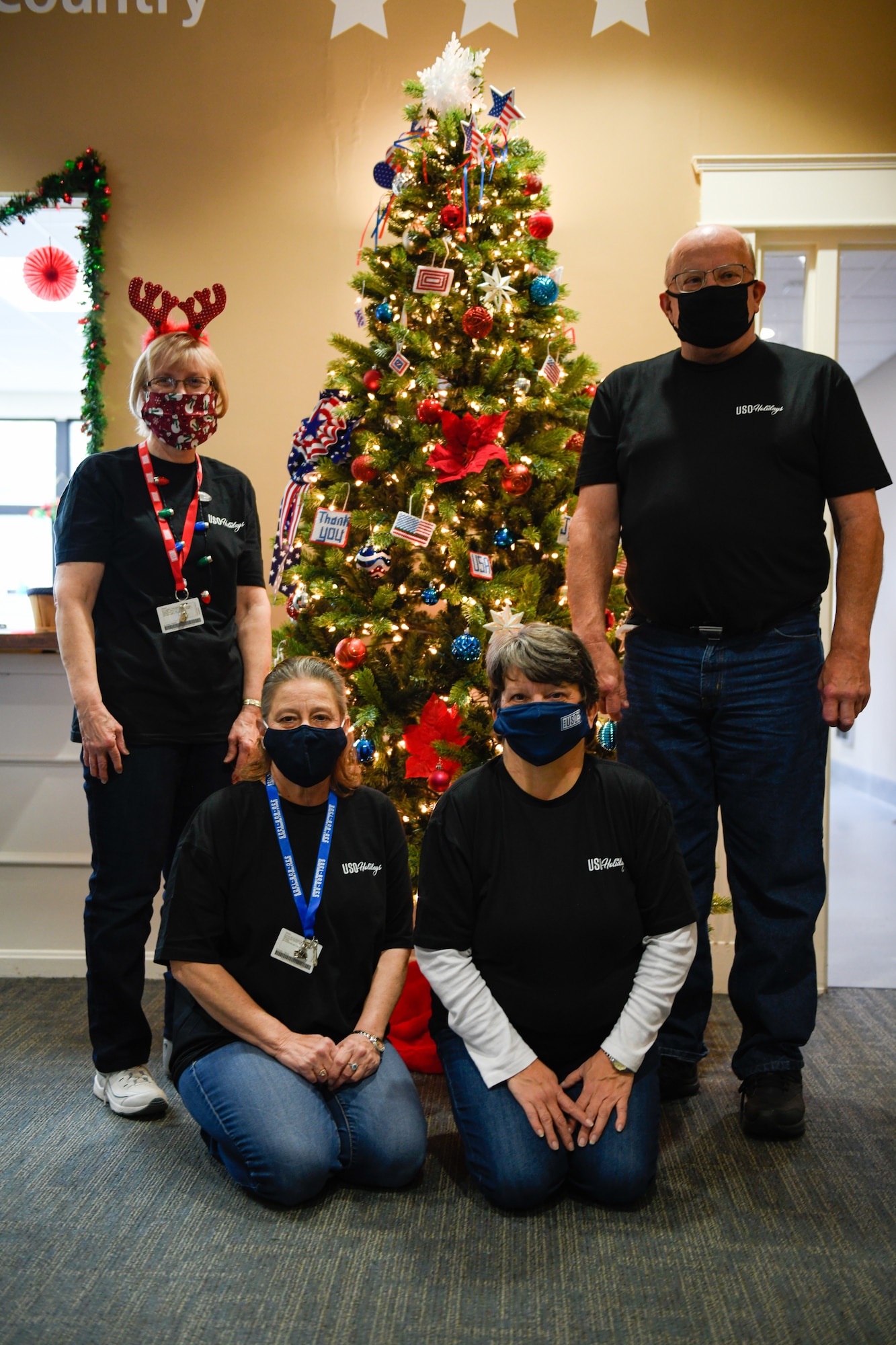 Volunteers of the USO of Northern Ohio pose in front of a Christmas tree during the Winter Wonderland event, Dec. 5, 2021, here.