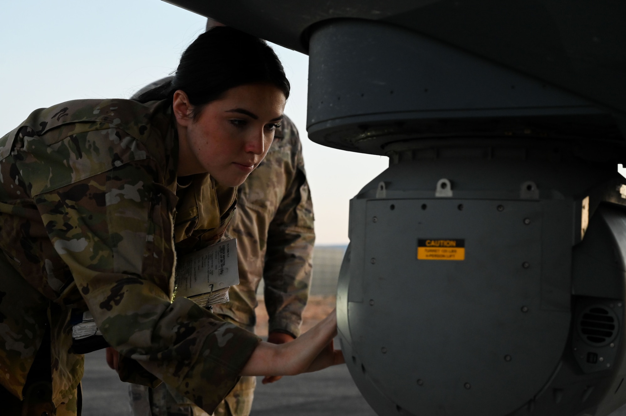 A loadmaster student performs pre-flight inspections.