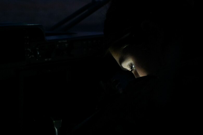 A loadmaster student performs pre-flight inspections.