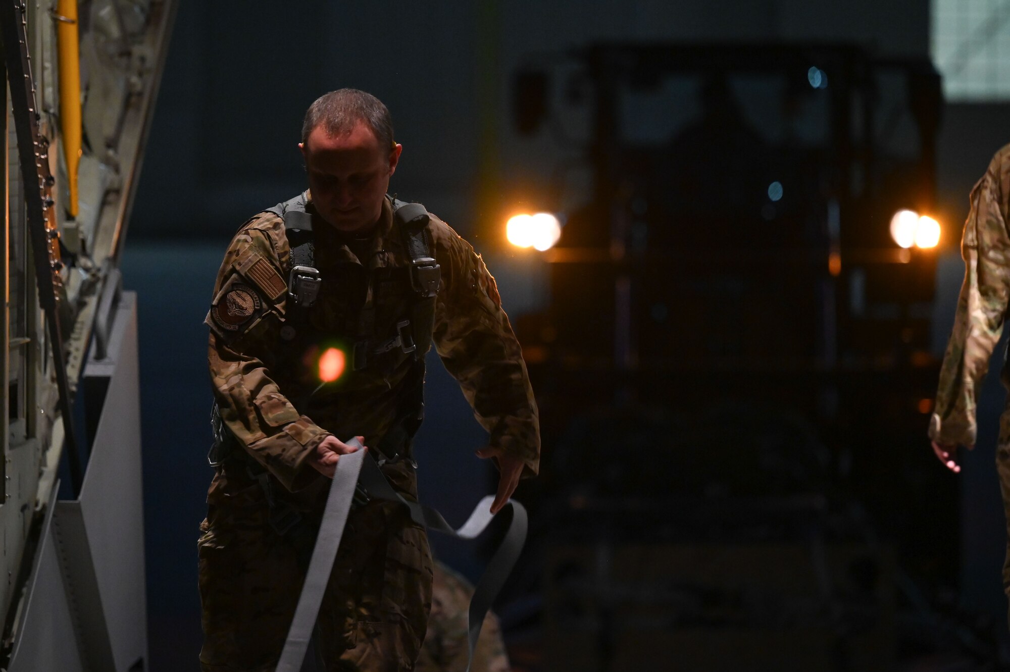 A loadmaster prepares to load cargo onto an aircraft.
