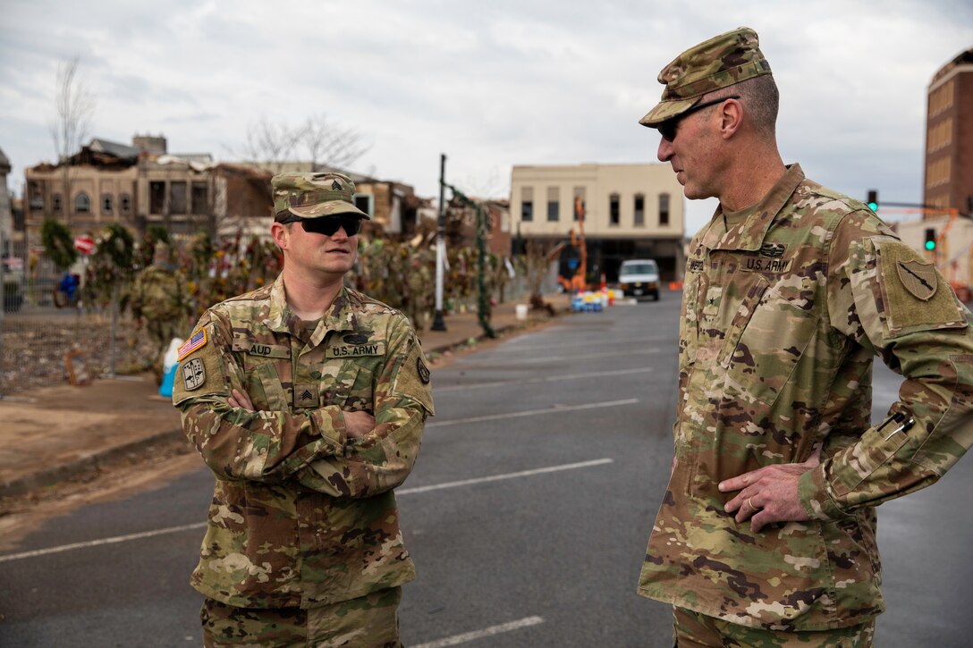 Kentucky Army National Guard's Sgt. Ryan Aud updates Brig. Gen. Brian Wertzler on traffic control points in Mayfield, Ky. on December 28th, 2021. Aud is a squad leader with the 1123rd Sapper Company and has been conducting traffic control points and health and welfare checks in support of tornado relief (U.S. Army photo by Andy Dickson).