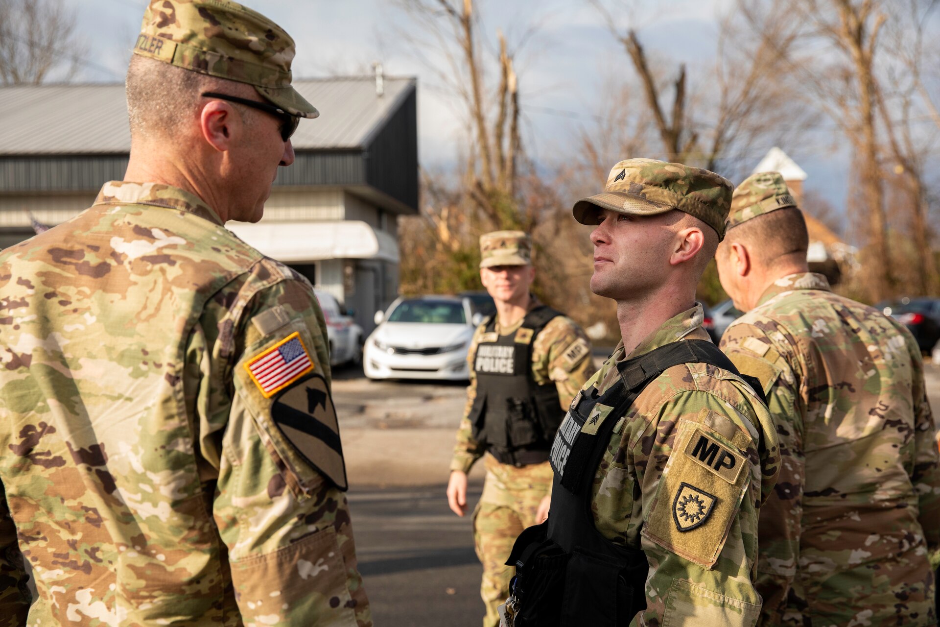 Kentucky Army National Guard's Sgt. Andrew Pile updates Brig. Gen. Brian Wertzler on traffic control points in Mayfield, Ky. on December 28th, 2021. Pile is a squad leader with the 223rd Military Police Company and has been conducting traffic control points in support of tornado relief (U.S. Army photo by Andy Dickson).