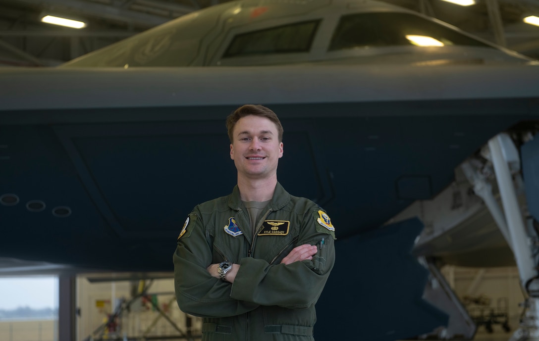 U.S. Air Force Capt. Kyle Cassady, 393rd Bomb Squadron B-2 Spirit instructor pilot, stands in front of a B-2 Spirit Stealth Bomber Dec. 28, 2021, at Whiteman Air Force Base, Missouri. Cassady is one of the pilots that will perform the B-2 flyover for the 108th Rose Bowl Game between The Ohio State Buckeyes and the University of Utah Utes. Cassady has family ties not only to The Ohio State University, but to Rose Bowl game history. Capt. Cassady’s father and grandfather both played for the Buckeyes and both won a Rose Bowl game during their football career. His grandfather, Howard “Hopalong” Cassady, won the Heisman Trophy in 1955. (U.S. Air Force photo by Tech. Sgt. Dylan Nuckolls)