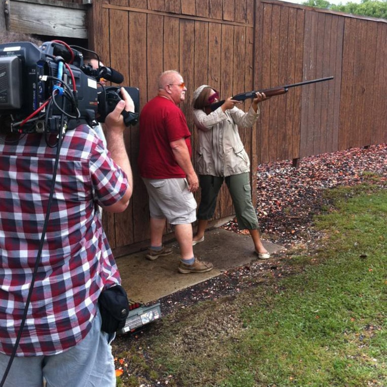 A woman fires a gun.