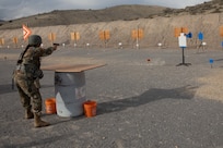 Staff Sgt. Sarah Hughes, with the Joint Forces Headquarters Battalion, shoots a steel target with her pistol during the three gun portion of the Utah National Guard Best Warrior Competition held on Camp Williams, Utah, Nov. 8, 2021