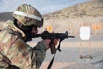 Master Sgt. Shaine Richards, Joint Forces Headquarters Battalion, shoots at silhouette targets using his M4 carbine for Utah’s Best Warrior Competition held on Camp Williams, Utah