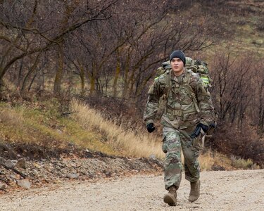 Sgt. Christian Xaygnaphong, a Soldier with the Utah Training Center, competes in a timed ruck march carrying a 40-pound rucksack on his back for the Best Warrior Competition on Camp Williams, Utah,