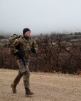 Sgt. Joshua White, a Soldier with the 97th Troop Command, picks up the pace to catch his competitors during a timed ruck march for the Best Warrior Competition on Camp Williams, Utah,