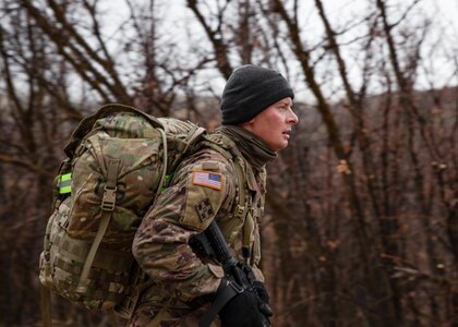 Sgt. Joshua White, a Soldier with the 97th Troop Command, runs through the brisk mountains during a timed ruck march for the Best War rior Competition on Camp Williams, Utah