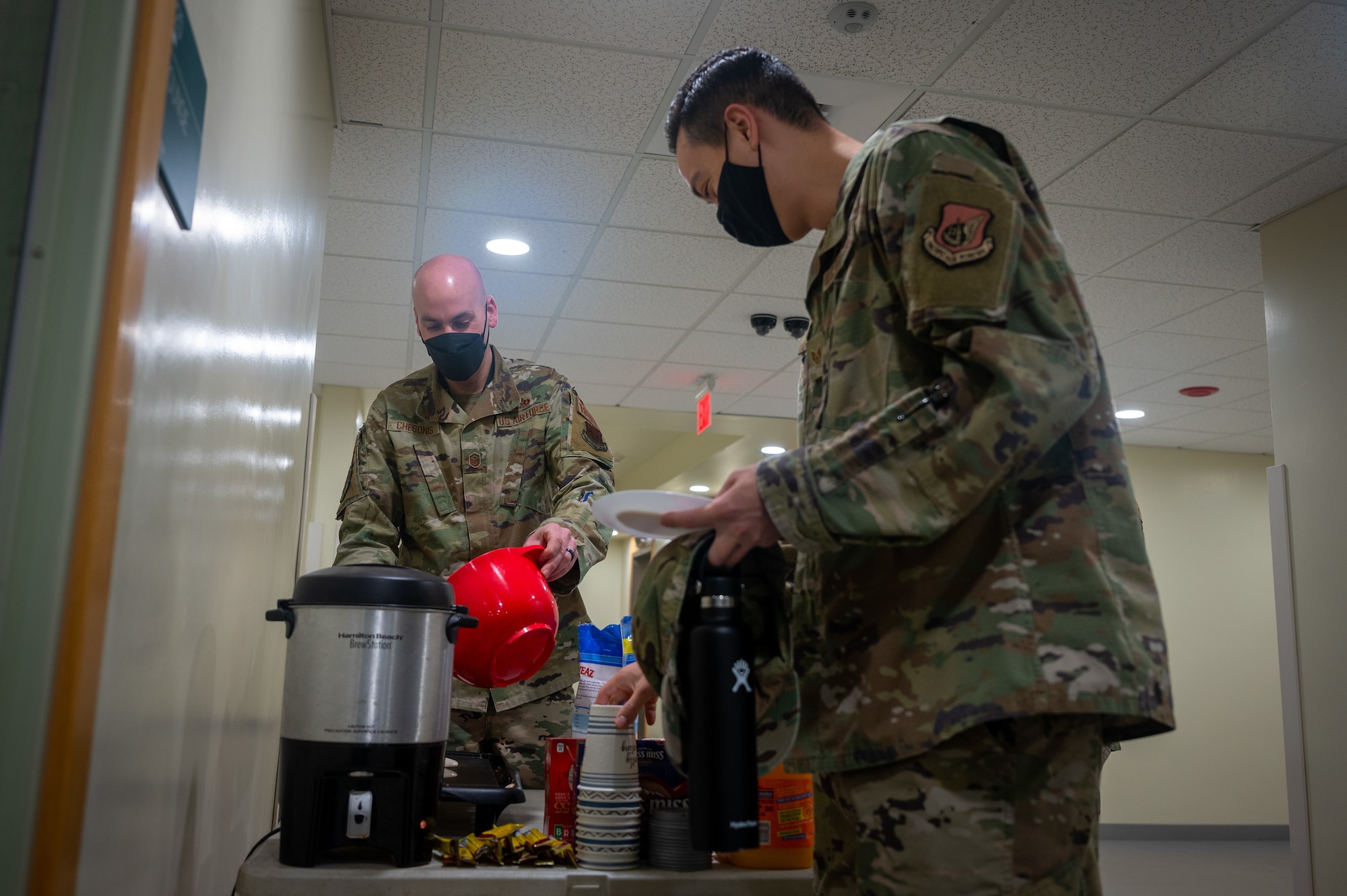 Master Sgt. Jason Chesonis, 694th Intelligence, Surveillance and Reconnaissance Group 1st Sgt., finishes cooking pancakes for a dorm resident during the “Storm the Dorm” event