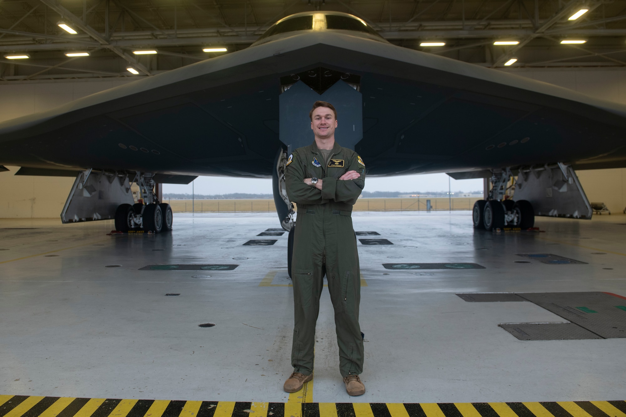 U.S. Air Force Capt. Kyle Cassady, 393rd Bomb Squadron B-2 Spirit instructor pilot, stands in front of a B-2 Spirit Stealth Bomber Dec. 28, 2021, at Whiteman Air Force Base, Missouri. Cassady is one of the pilots that will perform the B-2 flyover for the 108th Rose Bowl Game between The Ohio State Buckeyes and the University of Utah Utes. Cassady has family ties not only to The Ohio State University, but to Rose Bowl game history. Capt. Cassady’s father and grandfather both played for the Buckeyes and both won a Rose Bowl game during their football career. His grandfather, Howard “Hopalong” Cassady, won the Heisman Trophy in 1955. (U.S. Air Force photo by Tech. Sgt. Dylan Nuckolls)
