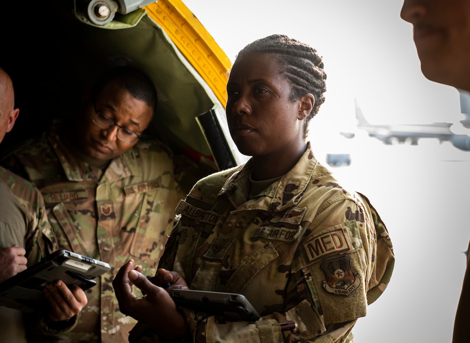 Female service member stands in during pre-flight meeting.