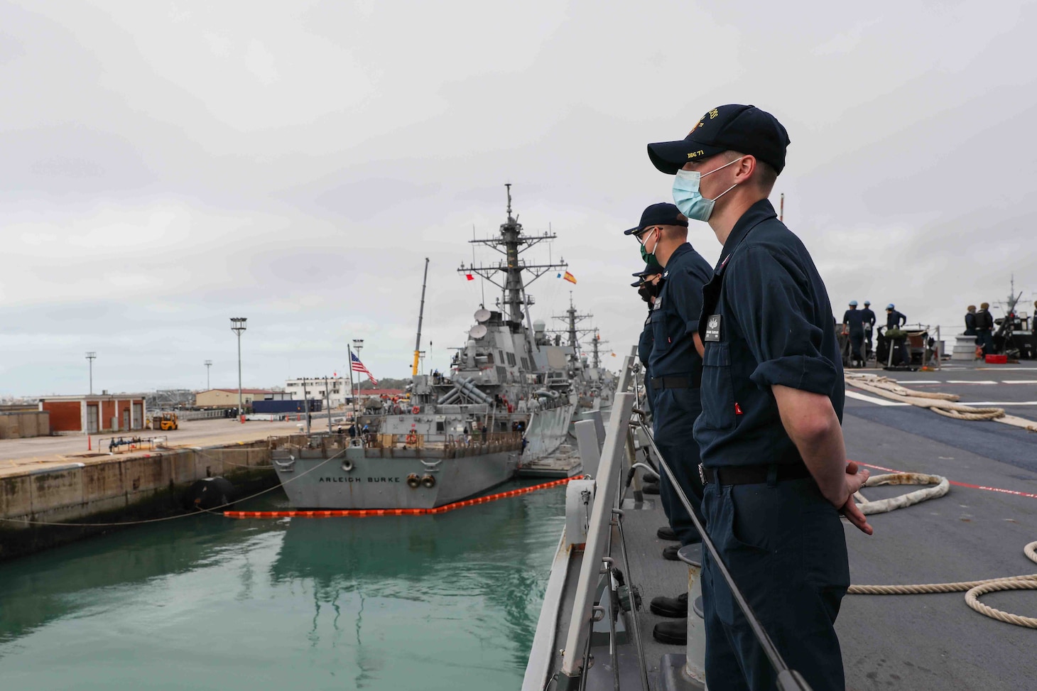 Cryptologic Technician (Collection) 2nd Class Benjamin Blanchard, right, assigned to the Arleigh Burke-class guided-missile destroyer USS Ross (DDG 71), mans the ship's rail as Ross gets underway from Naval Station Rota, Spain, Dec. 27, 2021. Ross, forward-deployed to Rota, Spain, is on its 12th patrol in the U.S. Sixth Fleet area of operations in support of regional allies and partners and U.S. national security interests in Europe and Africa. (U.S. Navy photo by Mass Communication Specialist 2nd Class Claire DuBois/Released)