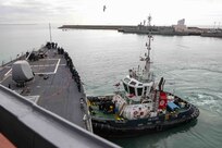 Sailors assigned to the Arleigh Burke-class guided-missile destroyer USS Ross (DDG 71) man the rails as the ship gets underway from Naval Station Rota, Spain to begin its 12th patrol, Dec. 27, 2021. Ross, forward-deployed to Rota, Spain, is on its 12th patrol in the U.S. Sixth Fleet area of operations in support of regional allies and partners and U.S. national security interests in Europe and Africa. (U.S. Navy photo by Mass Communication Specialist 2nd Class Claire DuBois/Released)