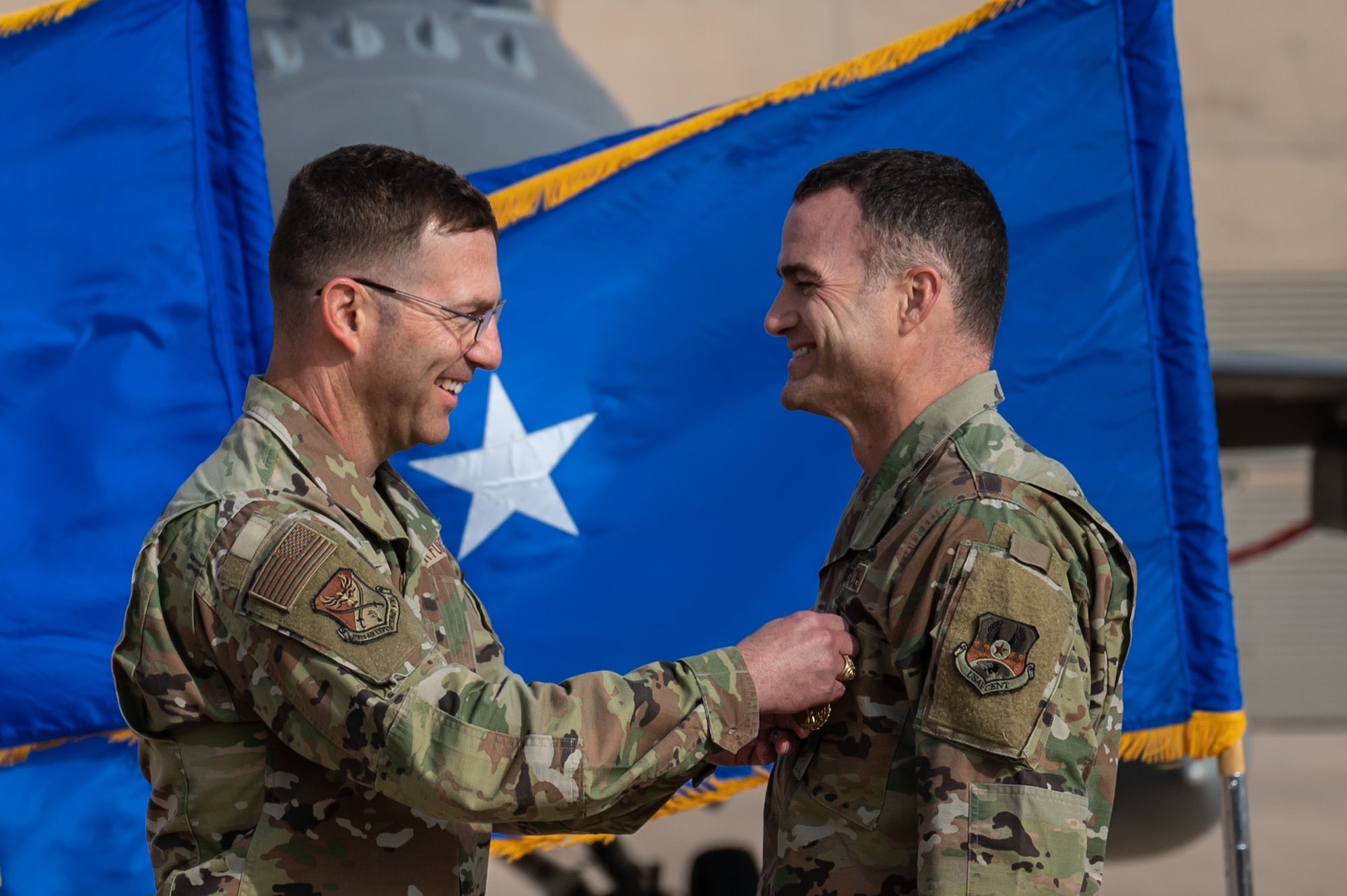 Col. Jason Smith, right, outgoing 378th Expeditionary Operations Group commander, receives the Meritorious Service Medal from Brig. Gen. Robert D. Davis, left, 378th Air Expeditionary Wing commander, during the 378th EOG change of command ceremony at Prince Sultan Air Base, Kingdom of Saudi Arabia, Dec. 26, 2021. The Meritorious Service Medal is awarded to members of the armed services who distinguish themselves by outstanding service to the United States. (U.S. Air Force photo by Staff Sgt. Christina Graves)