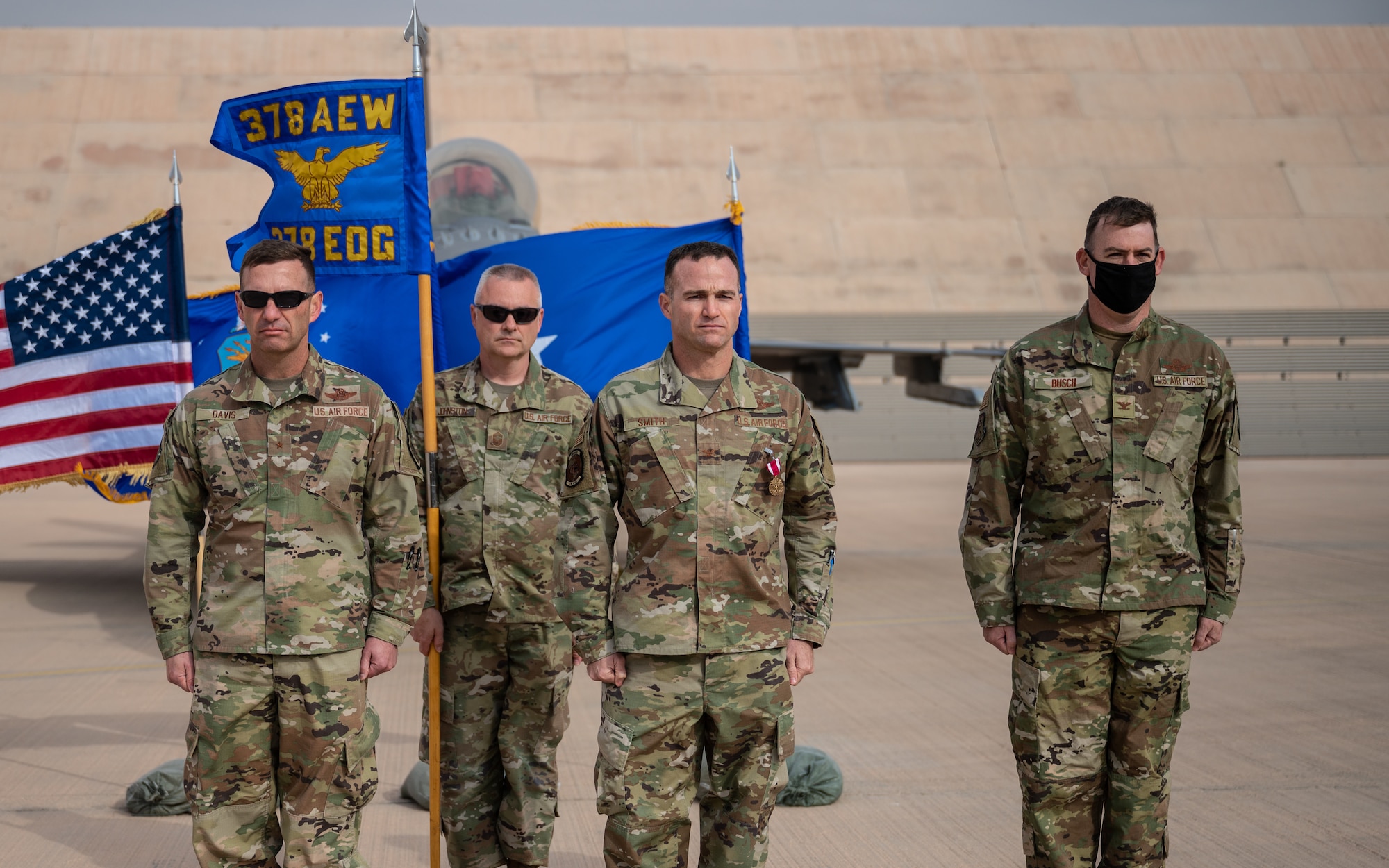 Brig. Gen. Robert D. Davis, 378th Air Expeditionary Wing commander, Col. Jason Smith, outgoing 378th Expeditionary Operations Group commander, and Col. Benjamin Busch, incoming 378th EOG commander, stand at the position of attention during the 378th EOG change of command ceremony at Prince Sultan Air Base, Kingdom of Saudi Arabia, Dec. 26, 2021. A change of command is a military tradition that represents a formal transfer of authority and responsibility for a unit from one commanding or flag officer to another. (U.S. Air Force photo by Staff Sgt. Christina Graves)