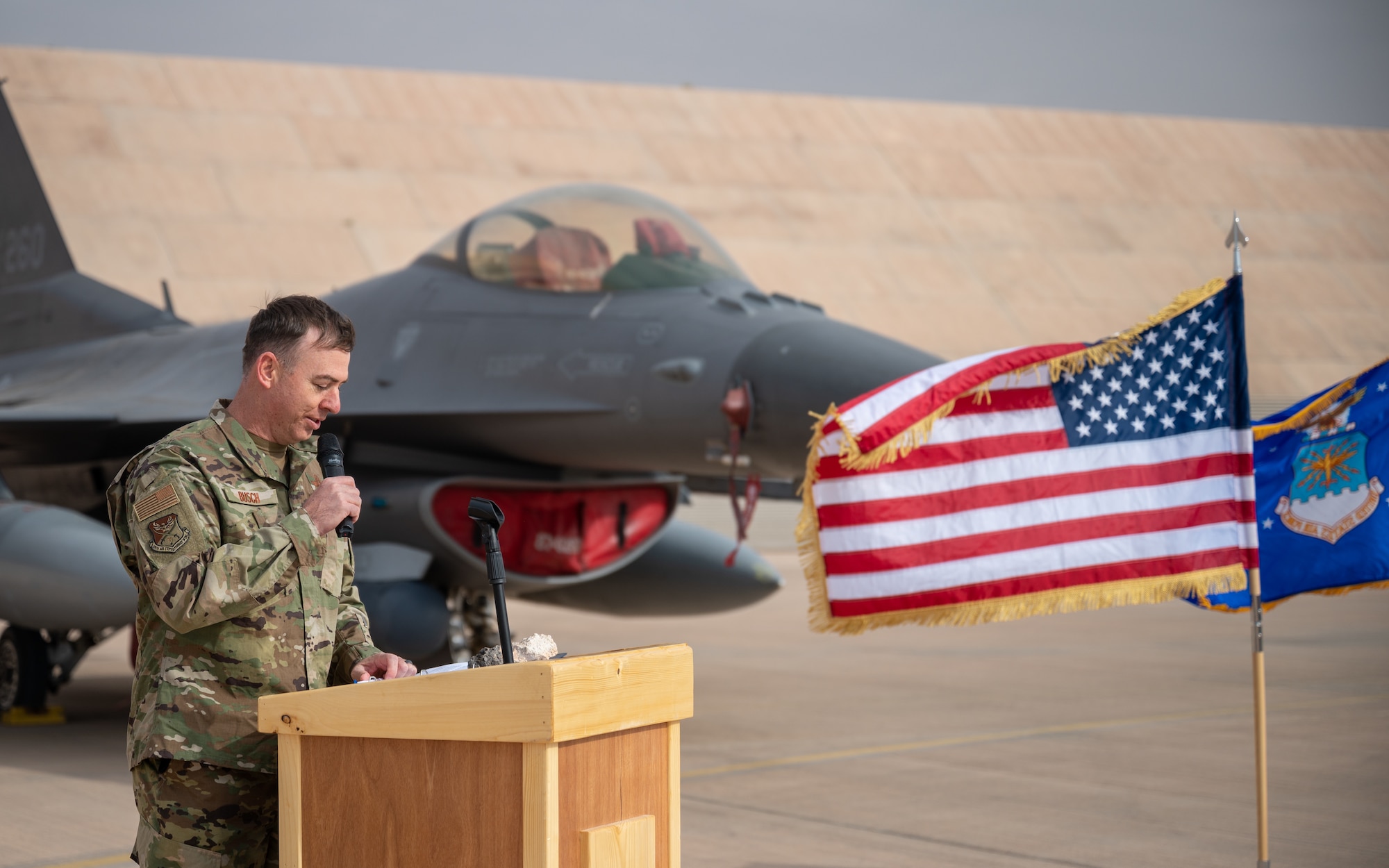 Col. Benjamin Busch, incoming 378th Expeditionary Operations Group commander, makes remarks during the 378th EOG change of command ceremony at Prince Sultan Air Base, Kingdom of Saudi Arabia, Dec. 26, 2021. A change of command is a military tradition that represents a formal transfer of authority and responsibility for a unit from one commanding or flag officer to another. (U.S. Air Force photo by Staff Sgt. Christina Graves)