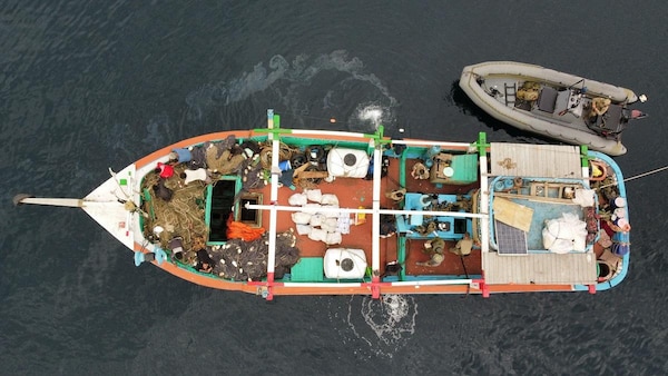 U.S. service members from coastal patrol ship USS Tempest (PC 2) and USS Typhoon (PC 5) inventory an illicit shipment of drugs while aboard a stateless dhow transiting international waters in the Arabian Sea, Dec. 27. (U.S. Navy photo)