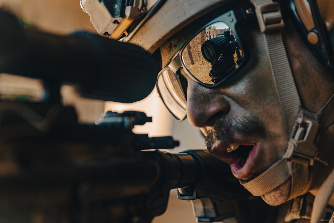 U.S. Marine Corps Lance Cpl. Johnny Luna, an infantry Marine with Battalion Landing Team 1/5, 31st Marine Expeditionary Unit, yells for his squad member while firing an M27 Infantry Automatic Rifle in an urban terrain during a motorized raid during MEU exercise on Camp Hansen, Okinawa, Japan, Dec. 16, 2021. The motorized raid was conducted to rehearse nontraditional ways of employing standard assets. MEUEX is a pre-deployment training exercise that validates and reinforces the MEU’s mission capabilities across all of the Marine subordinate elements. The 31st MEU, the Marine Corps’ only continuously forward-deployed MEU, provides a flexible and lethal force ready to perform a wide range of military operations as the premier crisis response force in the Indo-Pacific region.