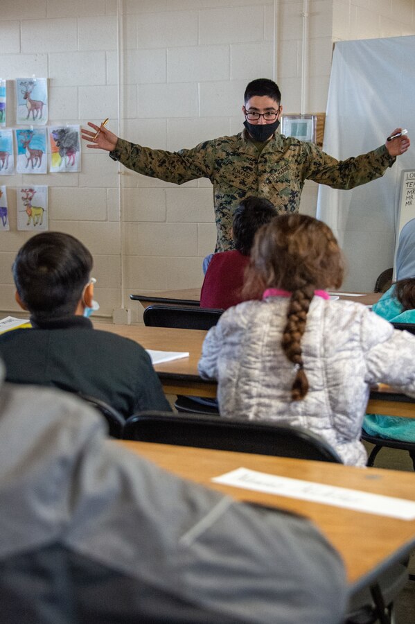 211229-N-YS140-019
Fort Pickett, Va. (Dec. 29, 2021) Lance Cpl. Ramiro Alvarado, administrative specialist, Charlie Company, 23rd Marine Regiment from Alamo, Texas instructs at Lonestar Academy, an educational facility that expands upon the curriculum already offered to Afghan evacuees. The Department of Defense, through U.S. Northern Command, and in support of the Department of Homeland Security, is providing transportation, temporary housing, medical screening, and general support for at least 50,000 Afghan evacuees at suitable facilities, in permanent or temporary structures, as quickly as possible. This initiative provides Afghan personnel essential support at secure locations outside Afghanistan. (U.S. Navy photo by Chief Mass Communication Specialist John Pearl)