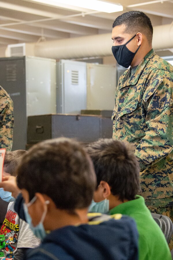 211229-N-YS140-029
Fort Pickett, Va. (Dec. 29, 2021) Lance Cpl. Adrian Moreno, rifleman, Alpha Company, 23rd Marine Regiment from Weslaco, Texas instructs at Lonestar Academy, an educational facility that expands upon the curriculum already offered to Afghan evacuees. The Department of Defense, through U.S. Northern Command, and in support of the Department of Homeland Security, is providing transportation, temporary housing, medical screening, and general support for at least 50,000 Afghan evacuees at suitable facilities, in permanent or temporary structures, as quickly as possible. This initiative provides Afghan personnel essential support at secure locations outside Afghanistan. (U.S. Navy photo by Chief Mass Communication Specialist John Pearl)