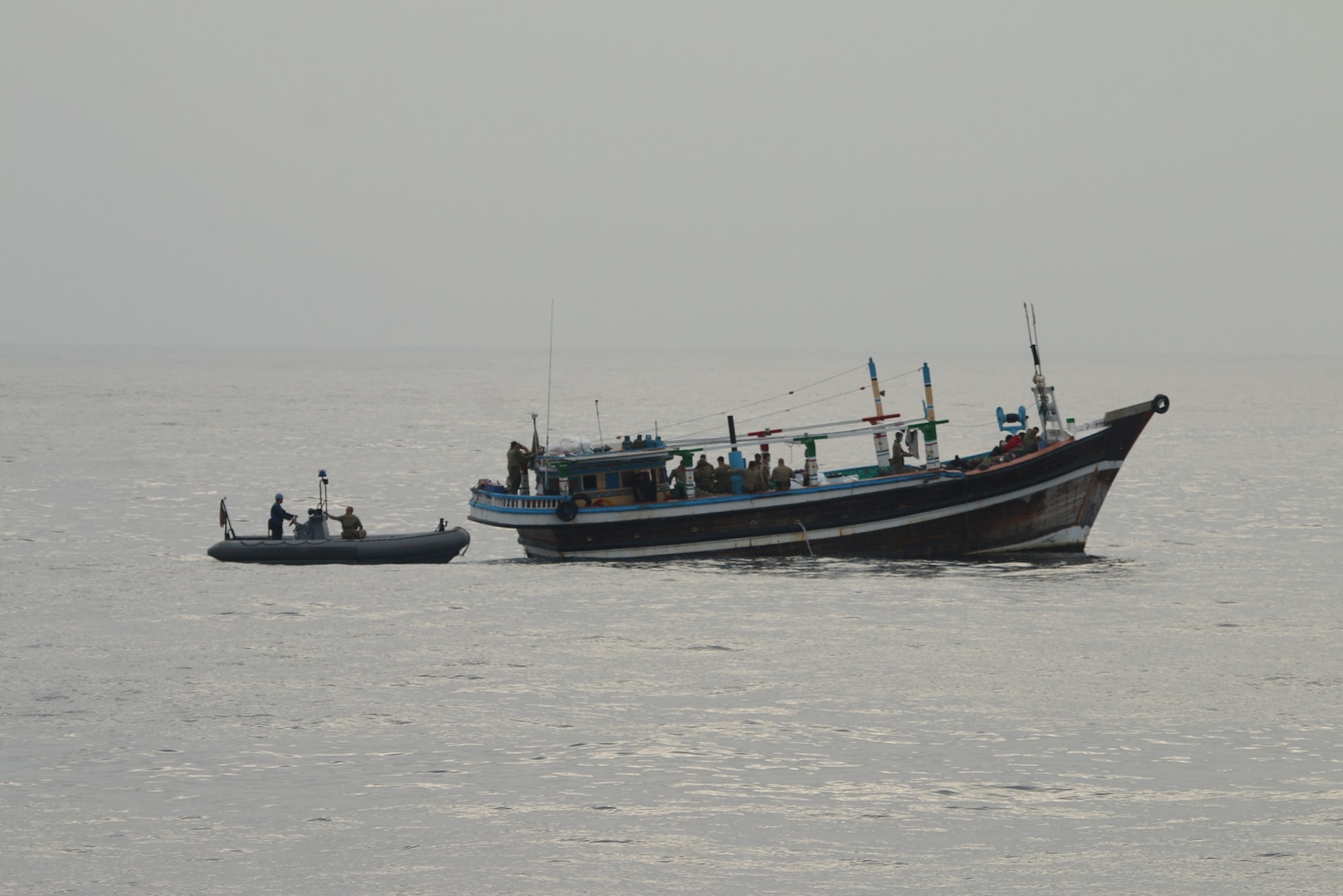 U.S. service members from coastal patrol ship USS Tempest (PC 2) and USS Typhoon (PC 5) inventory an illicit shipment of drugs while aboard a stateless dhow transiting international waters in the Arabian Sea, Dec. 27.