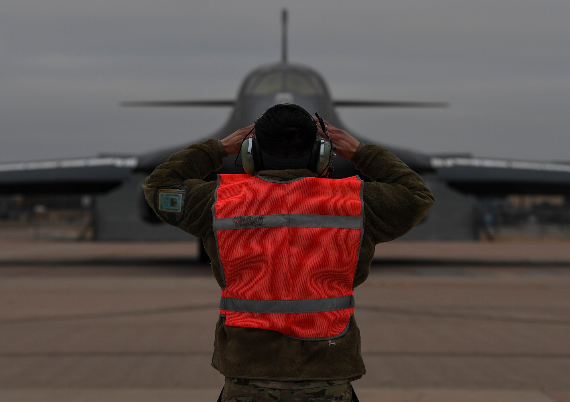 An Airman marshalls in a B-1 Lancer.