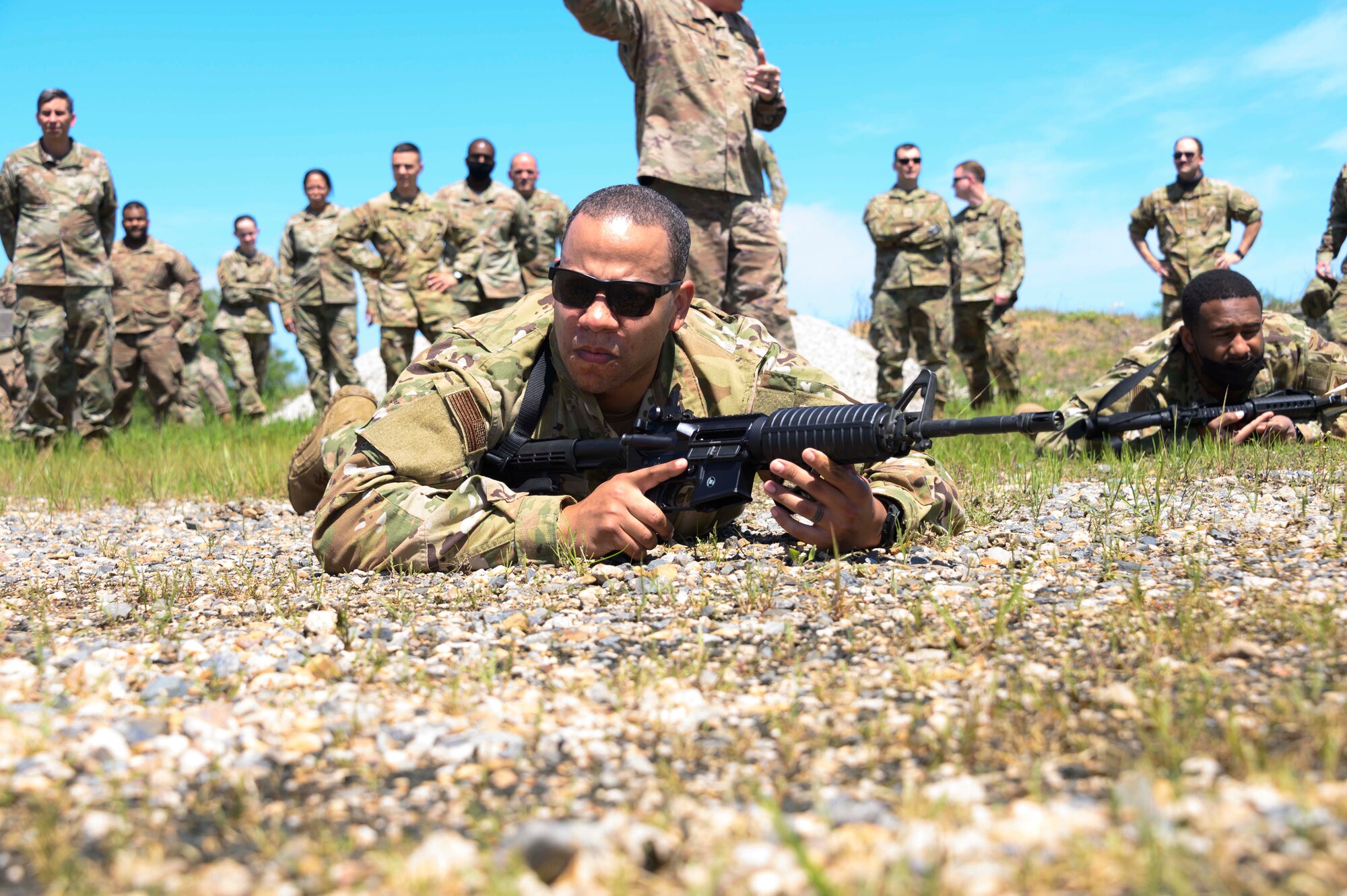 An Airman low crawls with a simulated M-4 Rifle.