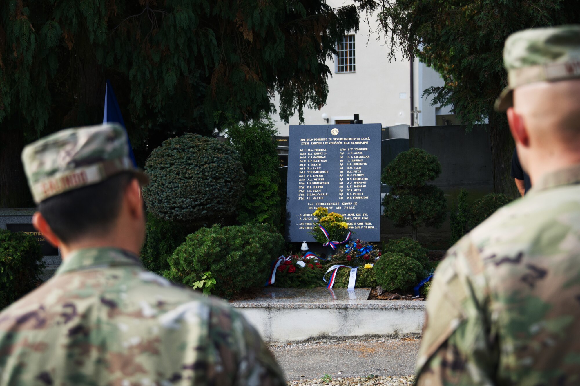 Photo of Airmen looking at a memorial plaque.