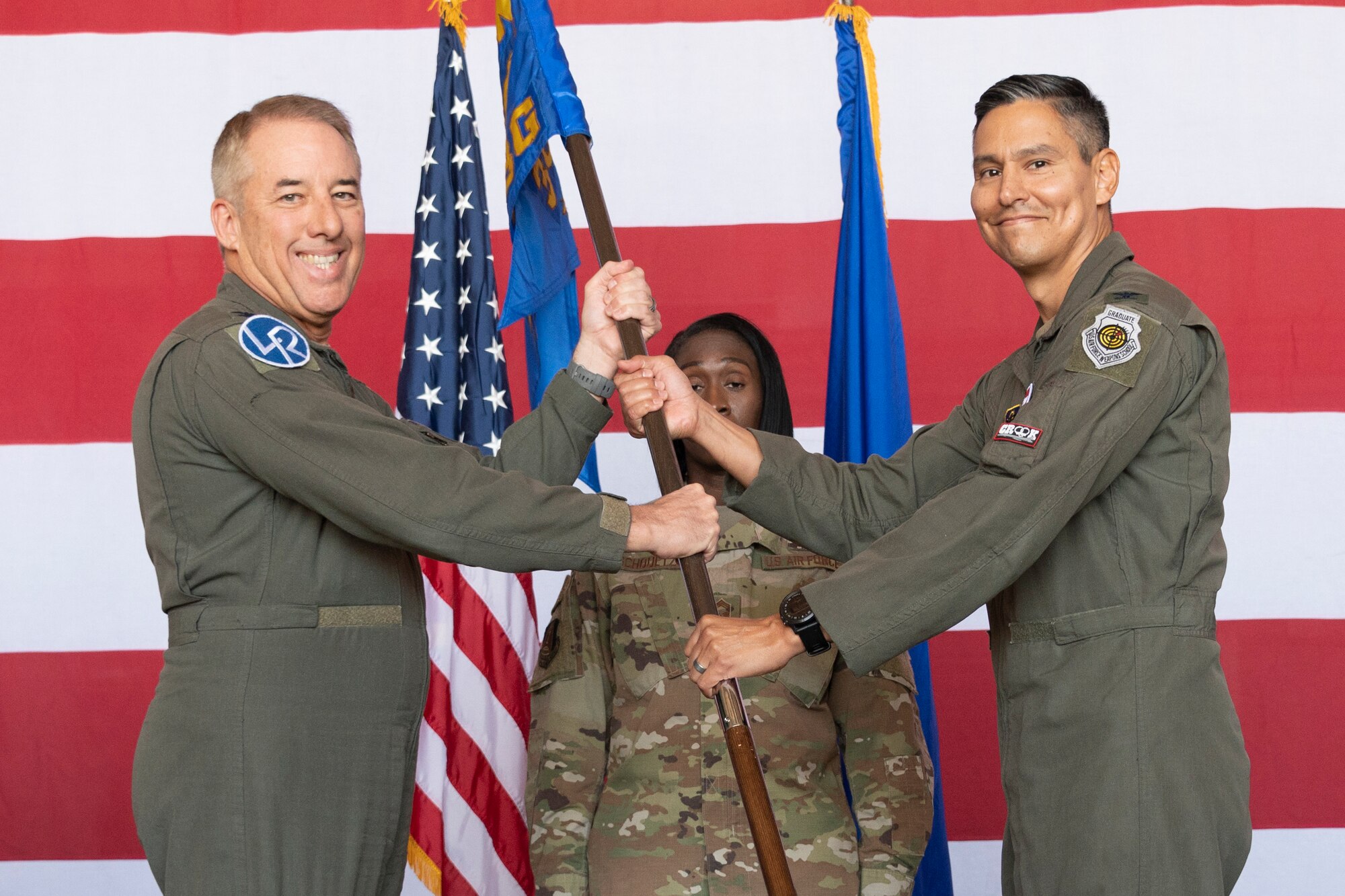 Airmen exchange a guidon.